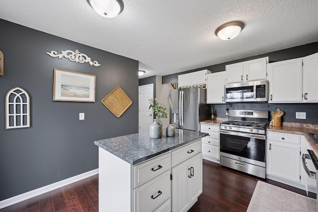 420 Pleasant Crest Cir, Annandale, MN 55302 - kitchen featuring stainless steel appliances, a textured ceiling, dark wood-type flooring, a center island, and white cabinetry