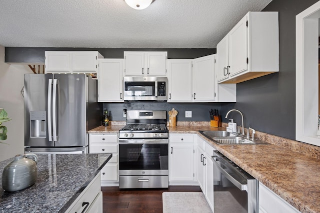 420 Pleasant Crest Cir, Annandale, MN 55302 - kitchen featuring stainless steel appliances, dark wood-style floors, white cabinetry, a textured ceiling, and stone countertops