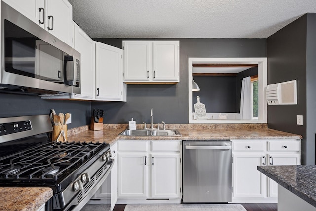 420 Pleasant Crest Cir, Annandale, MN 55302 - kitchen with stainless steel appliances, white cabinetry, and a textured ceiling