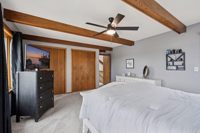 420 Pleasant Crest Cir, Annandale, MN 55302 - bedroom with beamed ceiling, light colored carpet, two closets, and ceiling fan