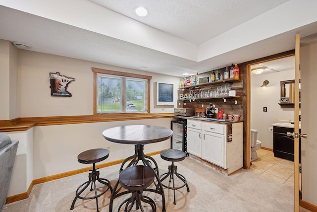 420 Pleasant Crest Cir, Annandale, MN 55302 - indoor wet bar featuring wine cooler, light carpet, and a textured ceiling
