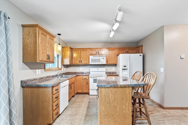 874 Independence Dr, Big Lake, MN 55309 - kitchen with white appliances, a kitchen bar, a center island, hanging light fixtures, and rail lighting