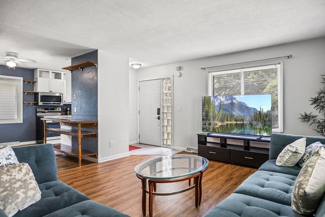 2717 22nd St, Minneapolis, MN 55406 - living room with a textured ceiling, wood finished floors, and a ceiling fan