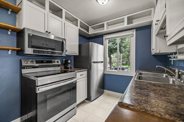 2717 22nd St, Minneapolis, MN 55406 - kitchen with appliances with stainless steel finishes, open shelves, dark countertops, white cabinets, and a textured ceiling