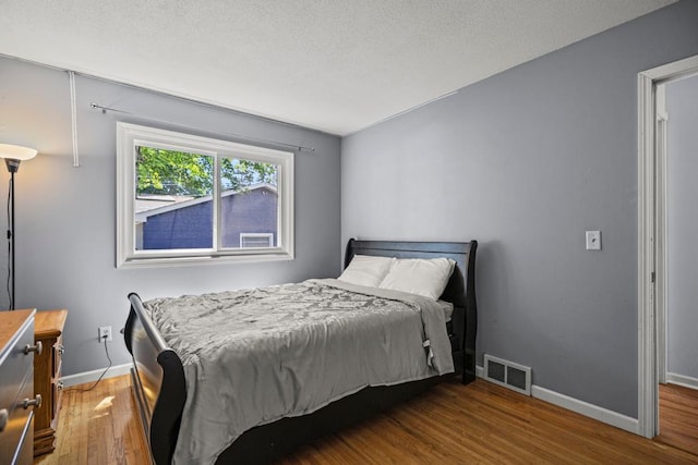 2717 22nd St, Minneapolis, MN 55406 - bedroom with wood finished floors and a textured ceiling