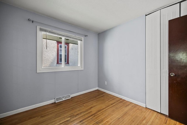 2717 22nd St, Minneapolis, MN 55406 - unfurnished bedroom with wood finished floors and a closet