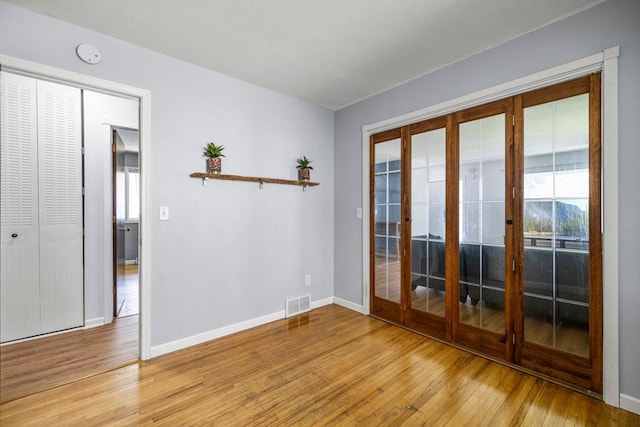 2717 22nd St, Minneapolis, MN 55406 - empty room featuring french doors, light wood-style floors, and a smoke detector