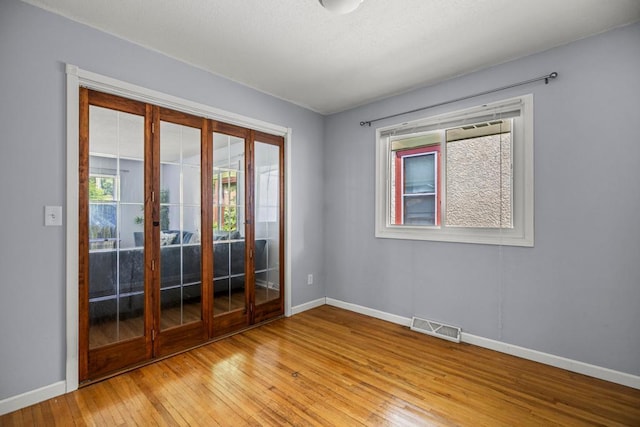 2717 22nd St, Minneapolis, MN 55406 - empty room featuring french doors and light wood-style flooring
