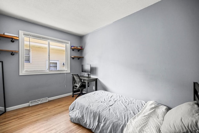 2717 22nd St, Minneapolis, MN 55406 - bedroom with wood finished floors and a textured ceiling