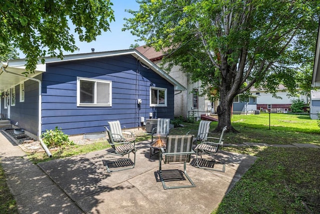 2717 22nd St, Minneapolis, MN 55406 - rear view of house featuring a patio, an outdoor fire pit, and a yard