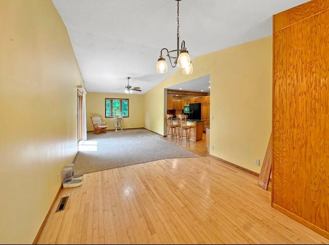 2117 Isleview Rd, Grand Rapids, MN 55744 - unfurnished living room with a chandelier, light wood-style floors, and a ceiling fan