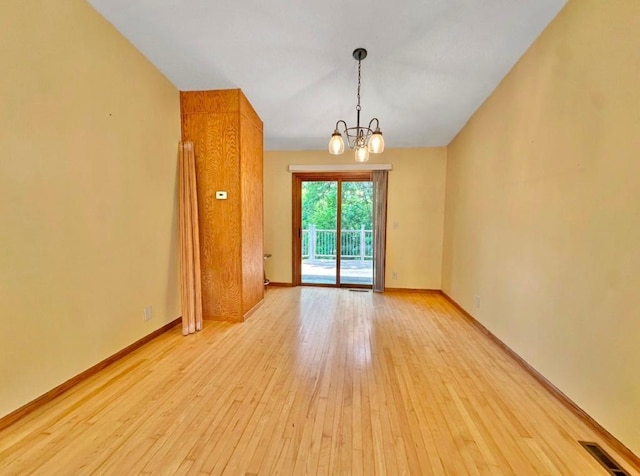 2117 Isleview Rd, Grand Rapids, MN 55744 - unfurnished room with light wood-style floors and a chandelier