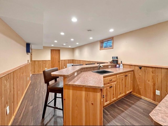 2117 Isleview Rd, Grand Rapids, MN 55744 - kitchen with wainscoting, wooden walls, dark wood-style floors, a kitchen bar, and recessed lighting