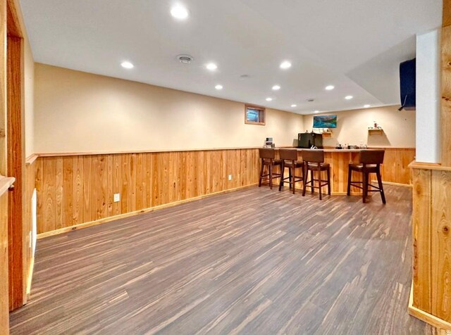 2117 Isleview Rd, Grand Rapids, MN 55744 - indoor wet bar featuring wood finished floors, a wainscoted wall, freestanding refrigerator, recessed lighting, and wood walls