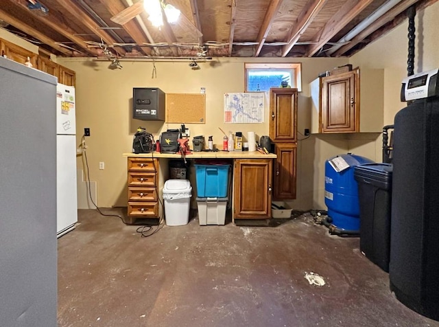 2117 Isleview Rd, Grand Rapids, MN 55744 - below grade area featuring a water softener, a water pressure tank, and freestanding refrigerator