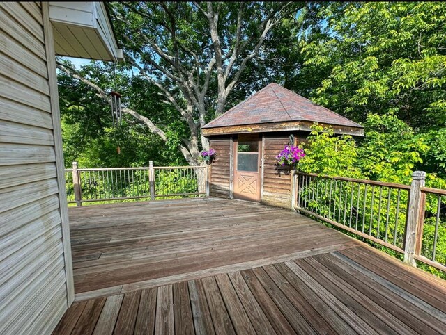 2117 Isleview Rd, Grand Rapids, MN 55744 - deck featuring view of wooded area and an outbuilding