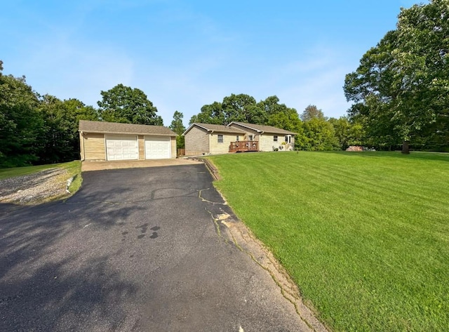 2117 Isleview Rd, Grand Rapids, MN 55744 - view of front of house featuring a garage, an outbuilding, and a front lawn