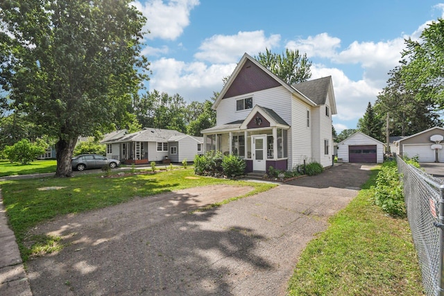 6429 Maple St, North Branch, MN 55056 - view of front of house featuring a garage, driveway, an outdoor structure, a front lawn, and a shingled roof
