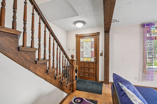 6429 Maple St, North Branch, MN 55056 - entryway with a textured ceiling, wood finished floors, and stairway