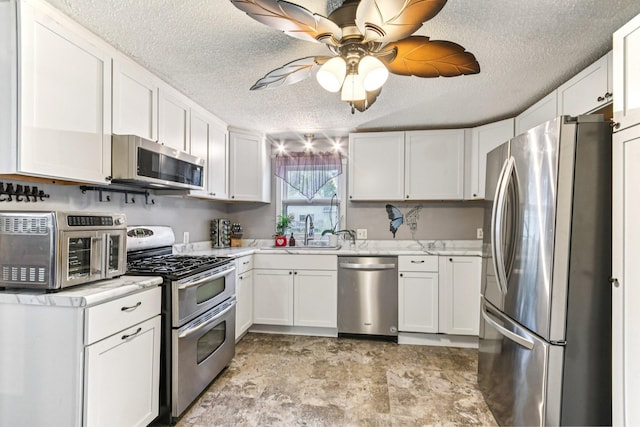 6429 Maple St, North Branch, MN 55056 - kitchen with stainless steel appliances, a textured ceiling, light countertops, white cabinets, and ceiling fan