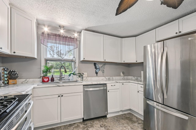 6429 Maple St, North Branch, MN 55056 - kitchen with stainless steel appliances, white cabinetry, a textured ceiling, ceiling fan, and light stone countertops