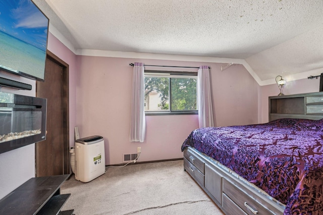 6429 Maple St, North Branch, MN 55056 - bedroom with light carpet, a textured ceiling, and vaulted ceiling