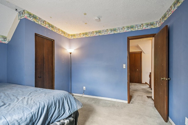 6429 Maple St, North Branch, MN 55056 - bedroom featuring a textured ceiling, carpet, and a closet