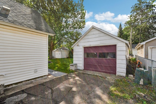 6429 Maple St, North Branch, MN 55056 - detached garage featuring asphalt driveway