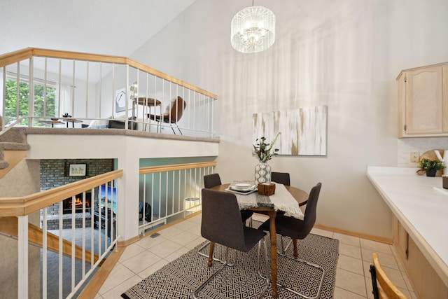 790 Winterberry Dr, Woodbury, MN 55125 - dining room with light tile patterned flooring, a high ceiling, and a chandelier