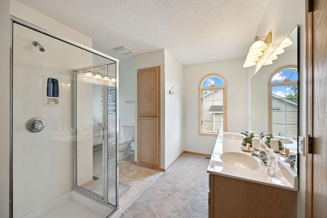790 Winterberry Dr, Woodbury, MN 55125 - bathroom with double vanity, a stall shower, and a textured ceiling