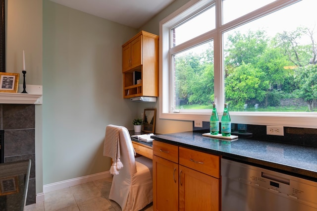 510 Grand Ave Unit 101, Saint Paul, MN 55102 - kitchen featuring stainless steel dishwasher, dark countertops, healthy amount of natural light, and light tile patterned floors