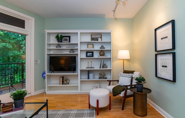 510 Grand Ave Unit 101, Saint Paul, MN 55102 - sitting room with wood finished floors and track lighting
