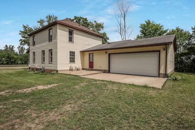 204 Main Ave, Wheeler, WI 54772 - view of front of home featuring a front yard, an attached garage, and a patio