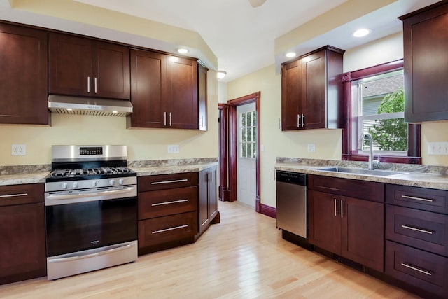 204 Main Ave, Wheeler, WI 54772 - kitchen featuring appliances with stainless steel finishes, ventilation hood, light wood finished floors, light countertops, and recessed lighting