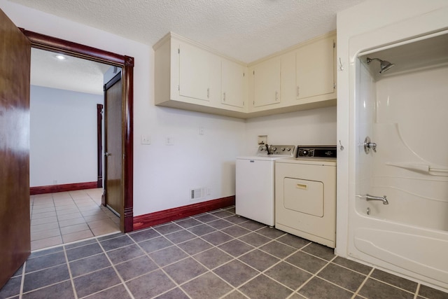 204 Main Ave, Wheeler, WI 54772 - laundry room featuring washer and dryer, dark tile patterned floors, and a textured ceiling