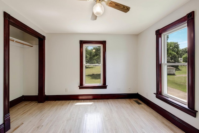 204 Main Ave, Wheeler, WI 54772 - unfurnished bedroom featuring multiple windows, light wood-type flooring, and ceiling fan