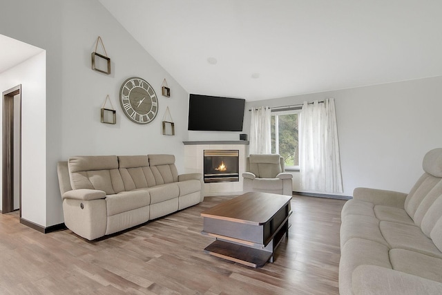 1219 Lakeview Pkwy, Buffalo, MN 55313 - living area with vaulted ceiling, wood finished floors, and a fireplace