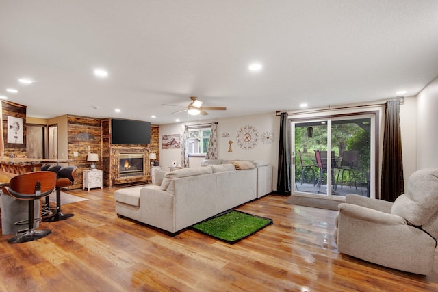 1219 Lakeview Pkwy, Buffalo, MN 55313 - living room with light wood-style flooring, healthy amount of natural light, ceiling fan, a brick fireplace, and recessed lighting