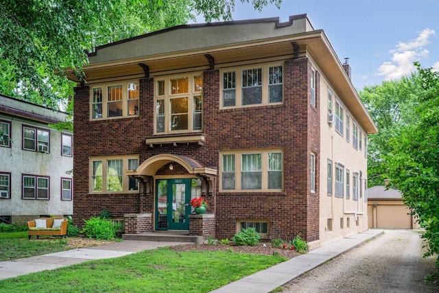 3533 Pleasant Ave Unit 3, Minneapolis, MN 55408 - view of front of house featuring brick siding, a chimney, a front lawn, and a garage