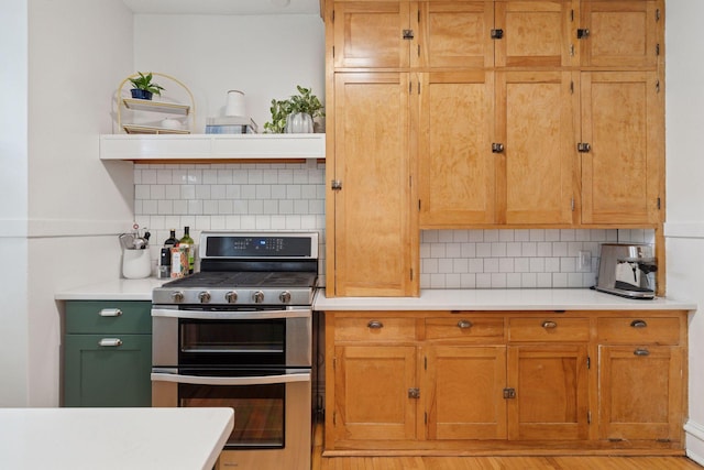 3533 Pleasant Ave Unit 3, Minneapolis, MN 55408 - kitchen with range with two ovens, decorative backsplash, and light countertops