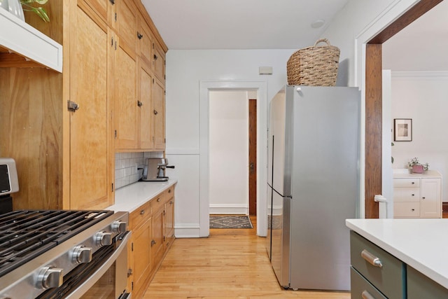 3533 Pleasant Ave Unit 3, Minneapolis, MN 55408 - kitchen with appliances with stainless steel finishes, light countertops, light wood-style flooring, and decorative backsplash