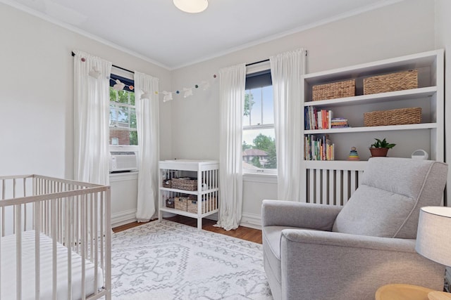3533 Pleasant Ave Unit 3, Minneapolis, MN 55408 - bedroom with crown molding, wood finished floors, a nursery area, and cooling unit