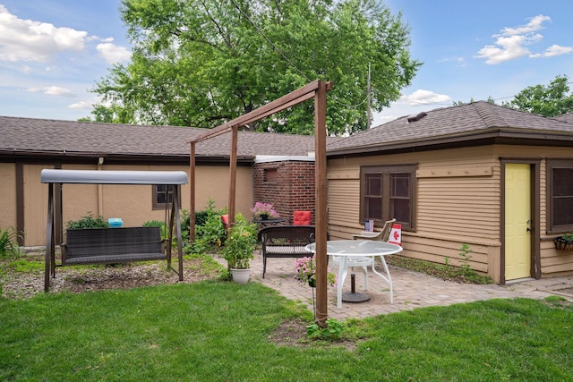 3533 Pleasant Ave Unit 3, Minneapolis, MN 55408 - back of house with a patio, a lawn, and a shingled roof