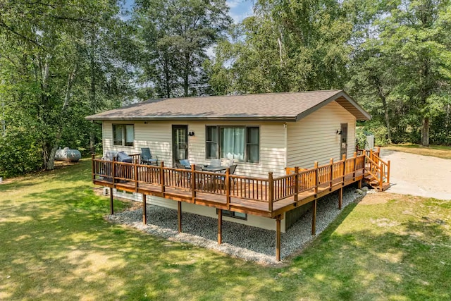 25463 County Road 267, Cohasset, MN 55721 - rear view of property featuring a deck, a yard, roof with shingles, and view of scattered trees