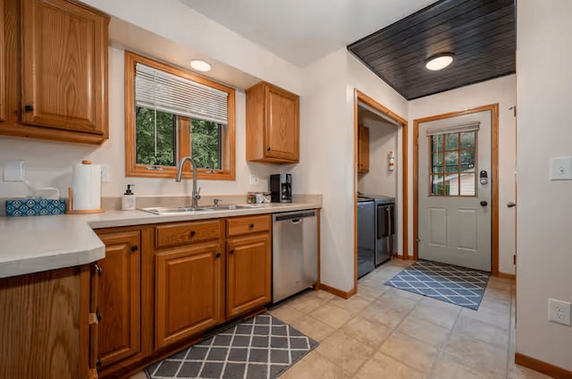 25463 County Road 267, Cohasset, MN 55721 - kitchen featuring dishwasher, washer and dryer, light countertops, and brown cabinetry