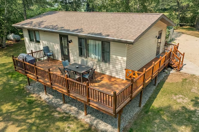 25463 County Road 267, Cohasset, MN 55721 - back of house featuring a deck, a lawn, a shingled roof, and outdoor dining area