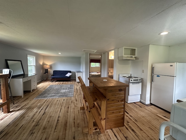 25463 County Road 267, Cohasset, MN 55721 - kitchen with white appliances, light wood-style floors, under cabinet range hood, recessed lighting, and open floor plan