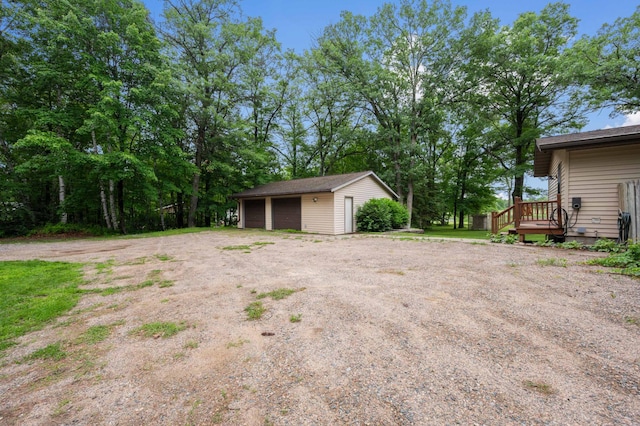 25463 County Road 267, Cohasset, MN 55721 - view of yard featuring a detached garage, an outdoor structure, and a wooden deck