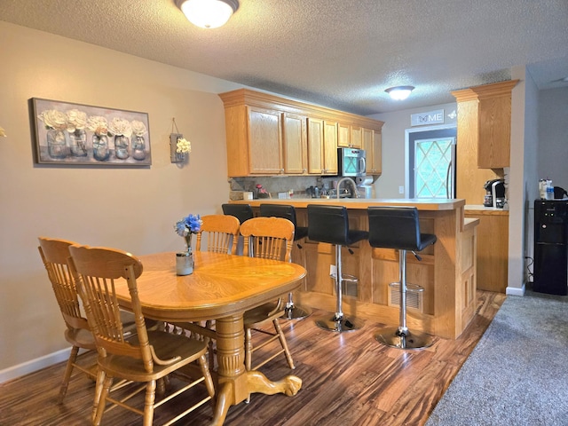 11348 Ibis St NW, Coon Rapids, MN 55433 - dining area featuring a textured ceiling and wood finished floors