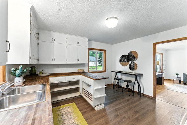 4951 Newton Ave N, Minneapolis, MN 55430 - kitchen featuring open shelves, dark wood-style flooring, white cabinetry, and a textured ceiling